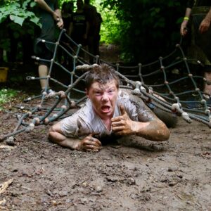 A photo of a scout covered in mud during the Atholl Experience