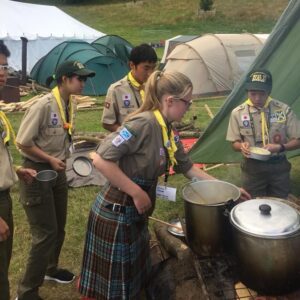 Scottish and Japanese Explorer Scouts cooking dinner at Blair Atholl