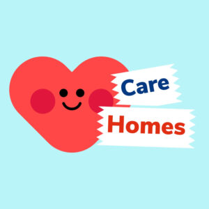 A red carton heart with a smiley face, and a ribbon with the words Care Homes