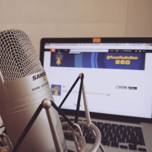 A photo of a microphone in front of a laptop showing the Radio Blair Soundcloud page