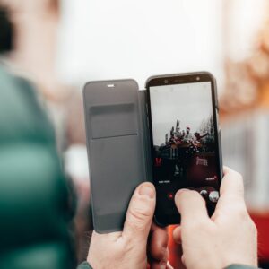 Someone taking a picture outside with a mobile phone